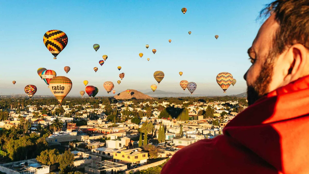 Hot air balloons drifting over the Avenue of the Dead at sunrise, Teotihuacán balloon flight from Mexico City